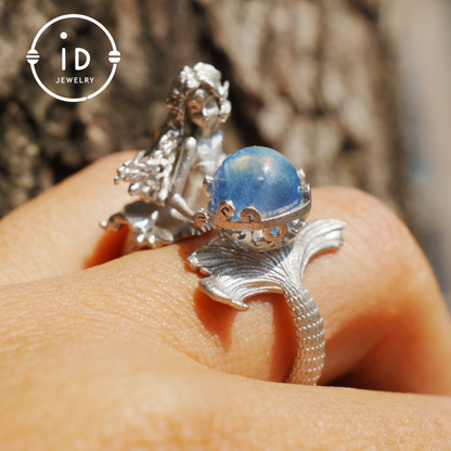 Handmade silver ring with seated mermaid and aquamarine stone, symbolic fantasy jewelry gift for women and ocean-inspired fairytale lovers