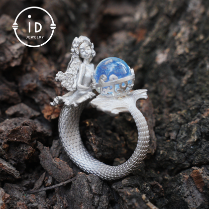 Handmade silver ring with seated mermaid and aquamarine stone, symbolic fantasy jewelry gift for women and ocean-inspired fairytale lovers