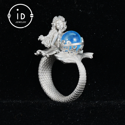Handmade silver ring with seated mermaid and aquamarine stone, symbolic fantasy jewelry gift for women and ocean-inspired fairytale lovers